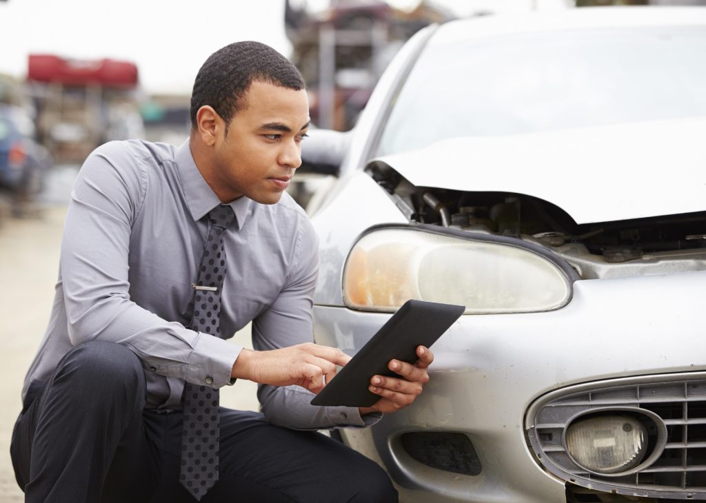 insurance appraiser checks vehicle damage
