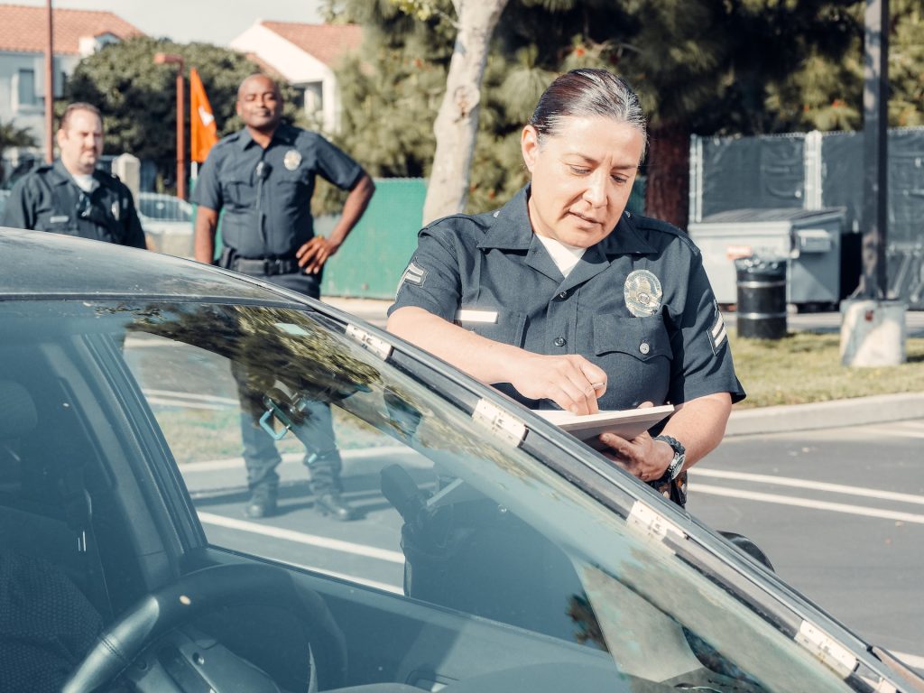 female officer writing traffic ticket