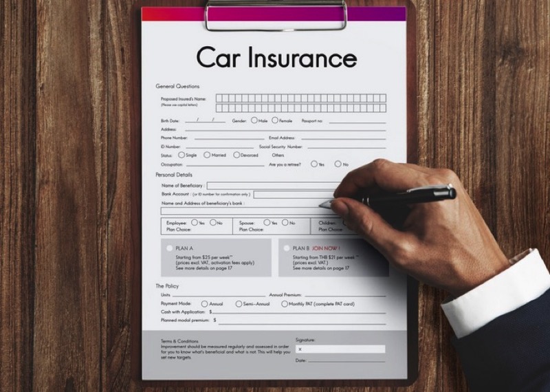 car insurance policy application on clipboard
