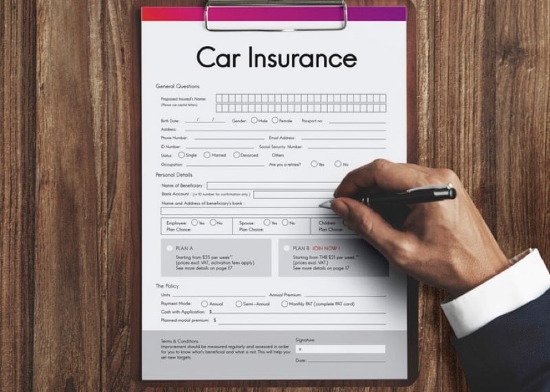 car insurance policy application on clipboard