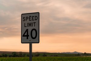 A 40 mph speed limit sign on the side of a highway, symbolizing how vehicle telematics can record a driver's speed.