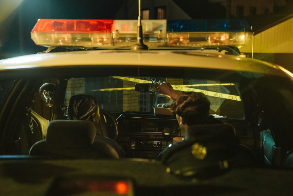 law enforcement inside a police car at night