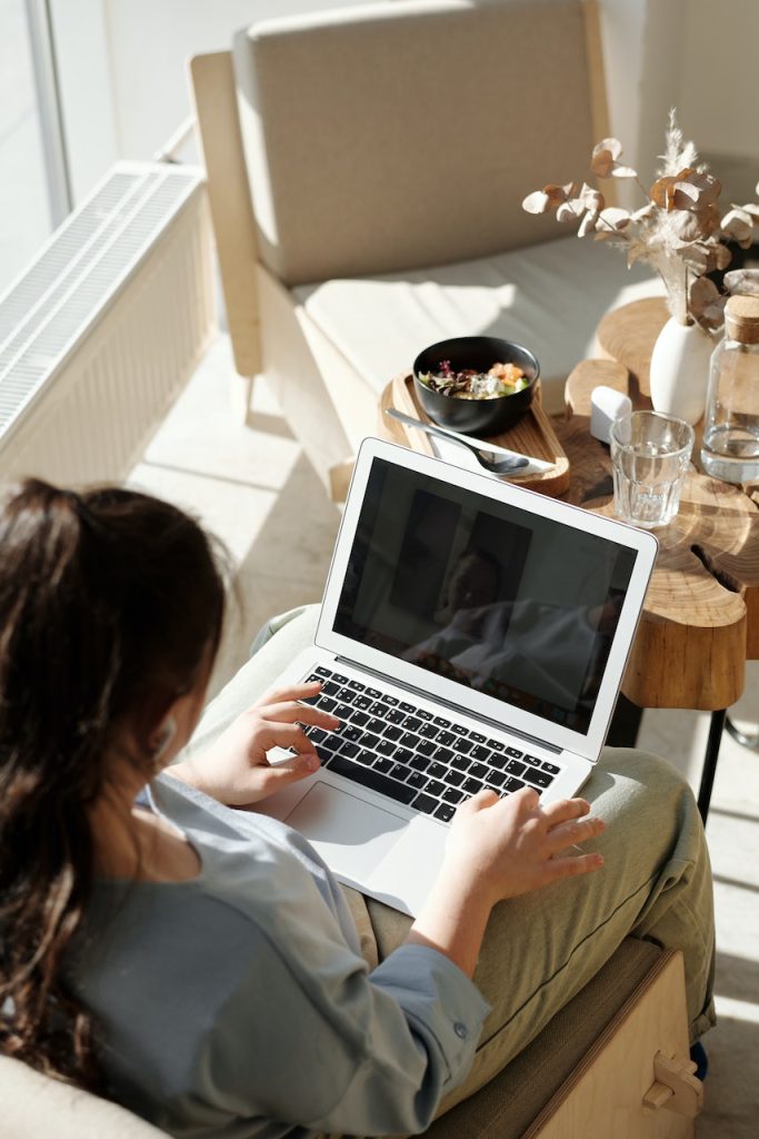 woman working in chair with laptop