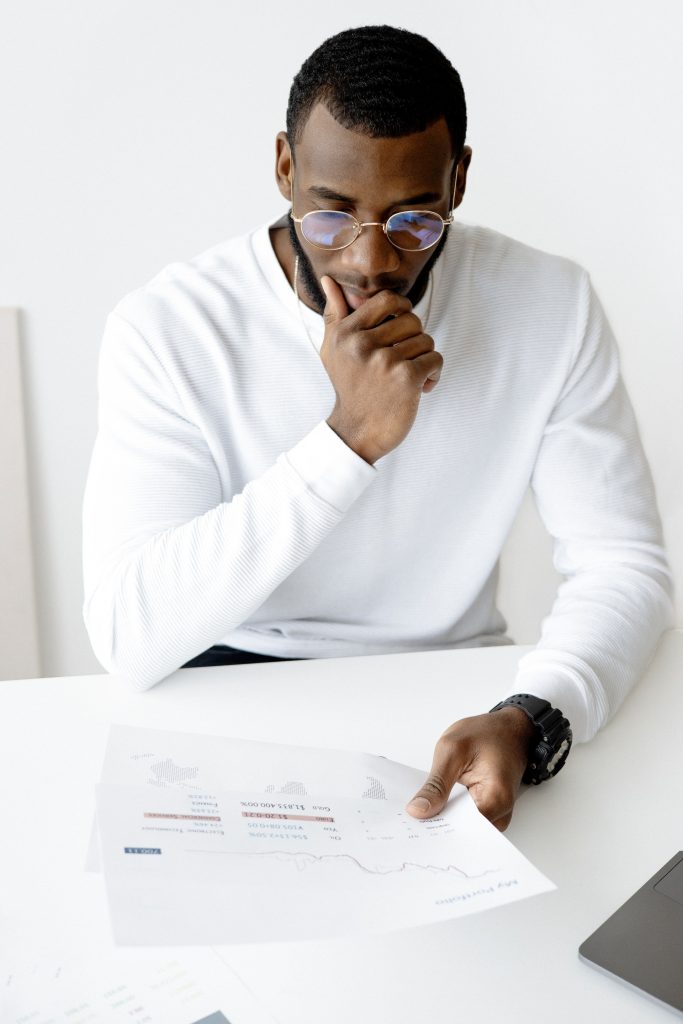 Man in glasses studying insurance options