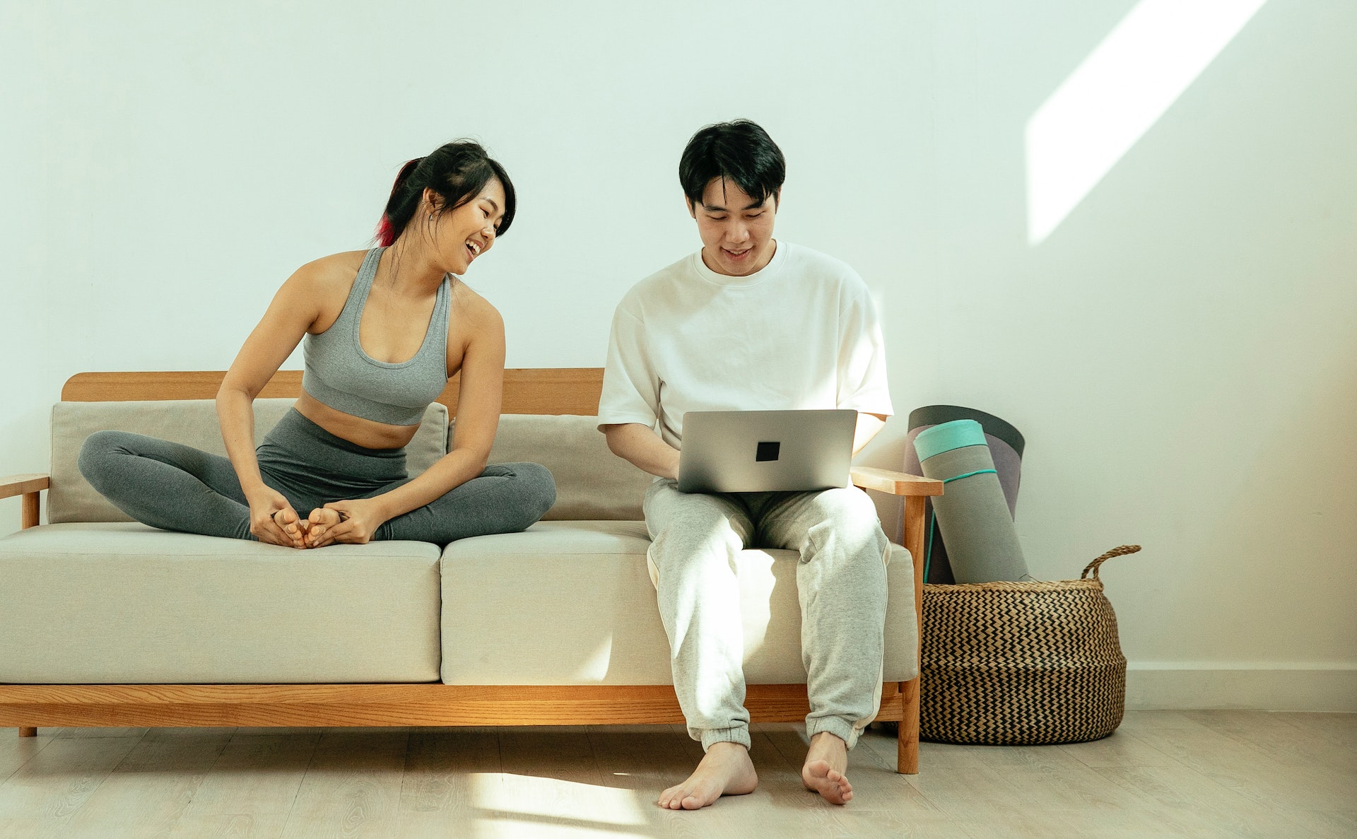 couple on a couch using a laptop computer