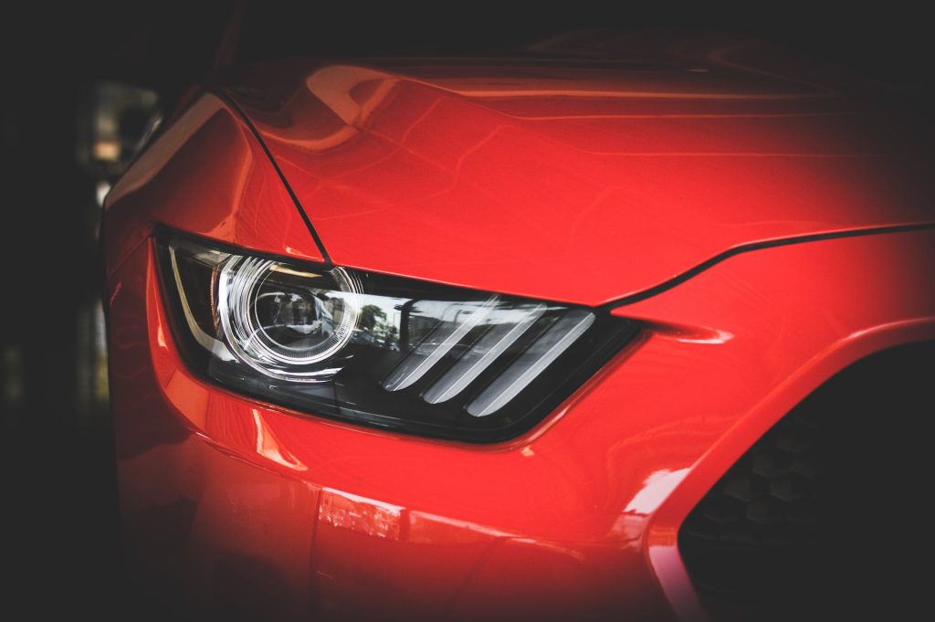 red ford mustang close up headlight