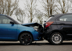 A rear-end collision on a road, symbolizing how an increase in accidents can drive up car insurance costs.