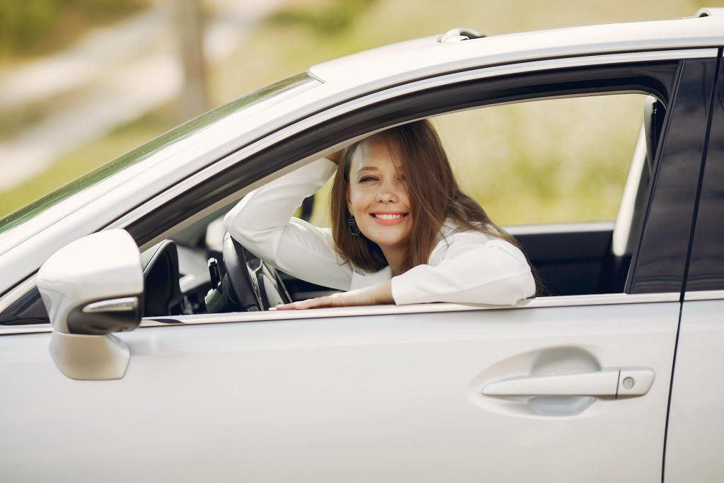 Woman driving in a white car