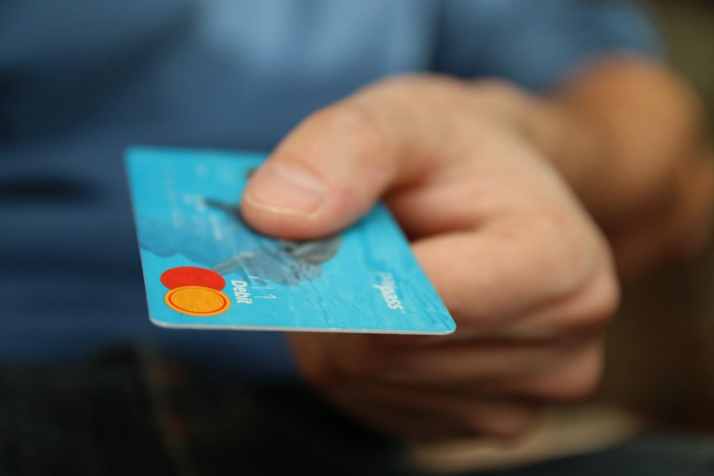 male holding a credit card