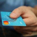 male holding a credit card
