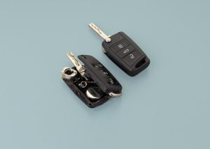 Two modern car keys shown side by side, symbolizing the high cost and complexity of replacing lost or broken vehicle keys.
