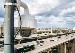 Cars moving smoothly on a modern freeway with digital signage, symbolizing the efficiency and safety improvements brought by Intelligent Transportation Systems (ITS).