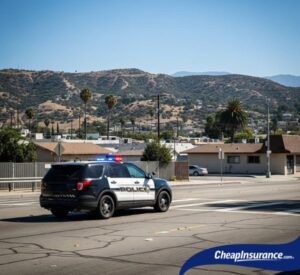 Police car driving through San Bernardino, CA, representing traffic violations that may lead to an SR22 filing.